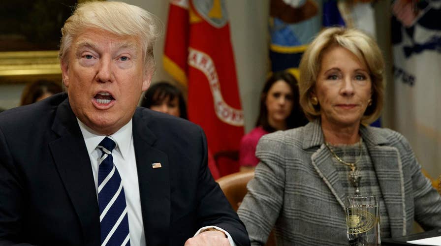 Trump praises DeVos for her 'toughness' and 'genius'