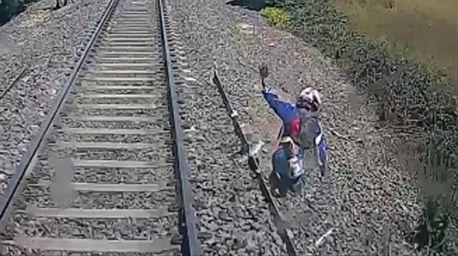 Biker cheats death, leaps from speeding train at last second