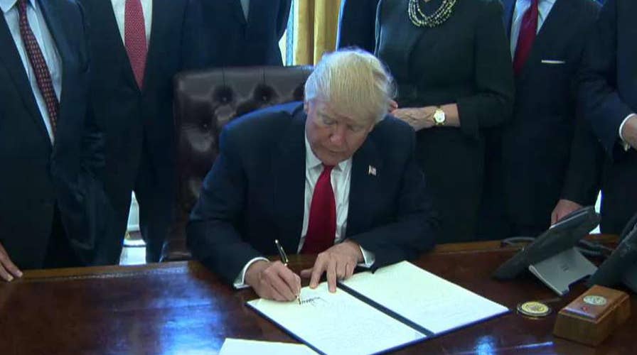 Trump signs order calling for rollback of regulations