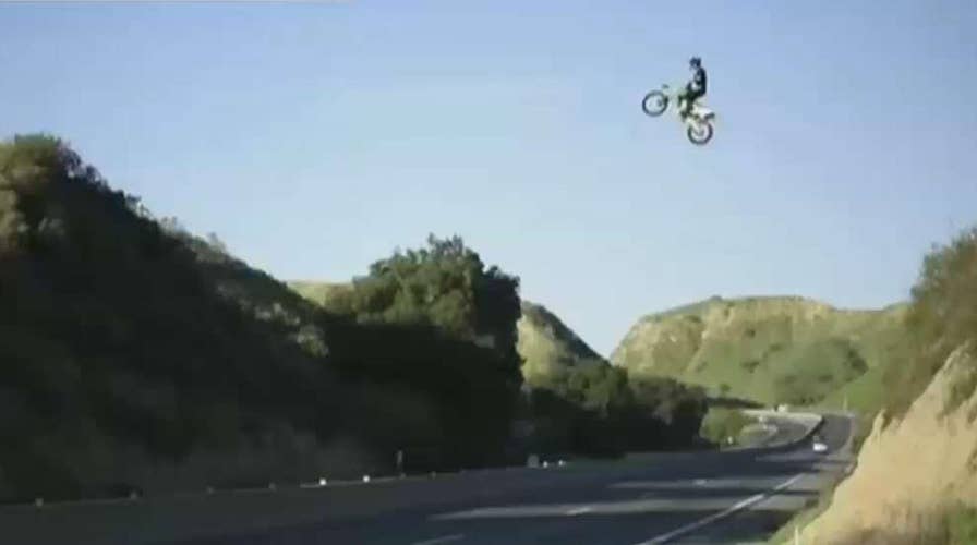 Dirt bike jumps over the freeway