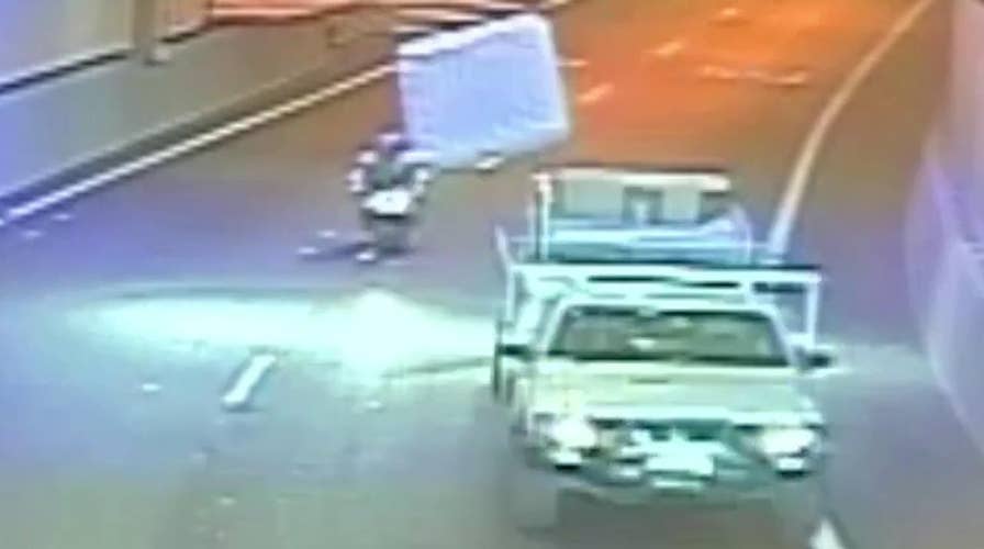 Flying mattress hits motorcyclist