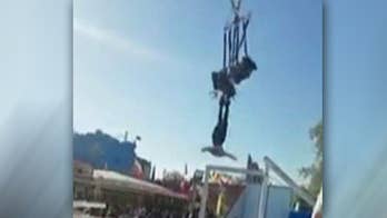 Woman slips from harness of thrill ride, flies through the air by her feet