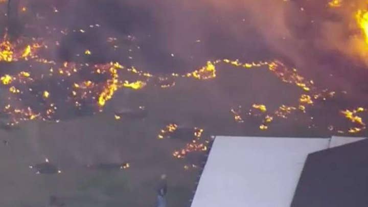 Florida residents evacuate as 'suspicious' fire spreads 