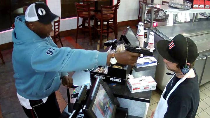 Watch clerk keep cool as thug points gun at his face