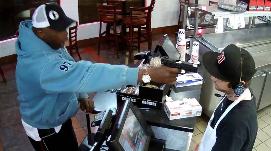Watch clerk keep cool as thug points gun at his face