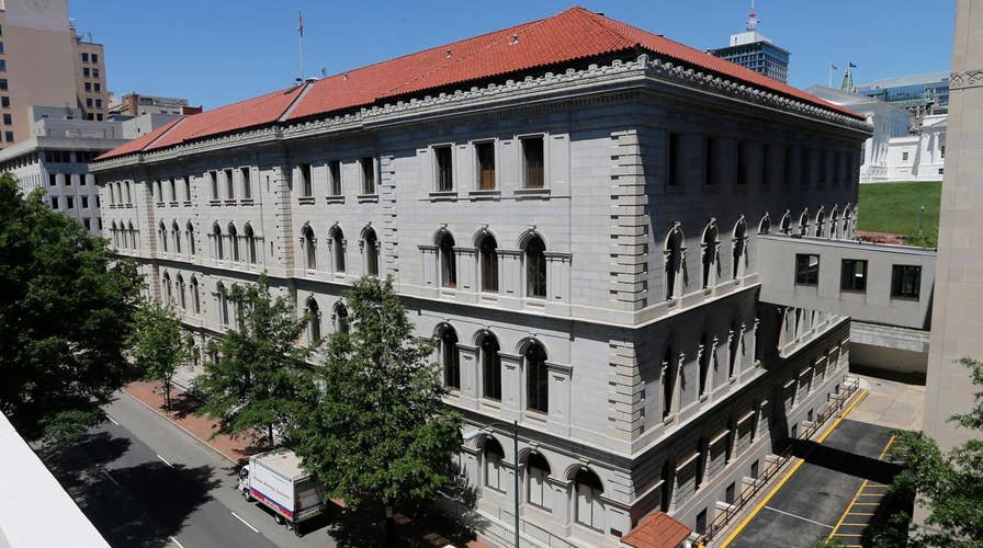 Federal appeals panel hears travel ban challenge