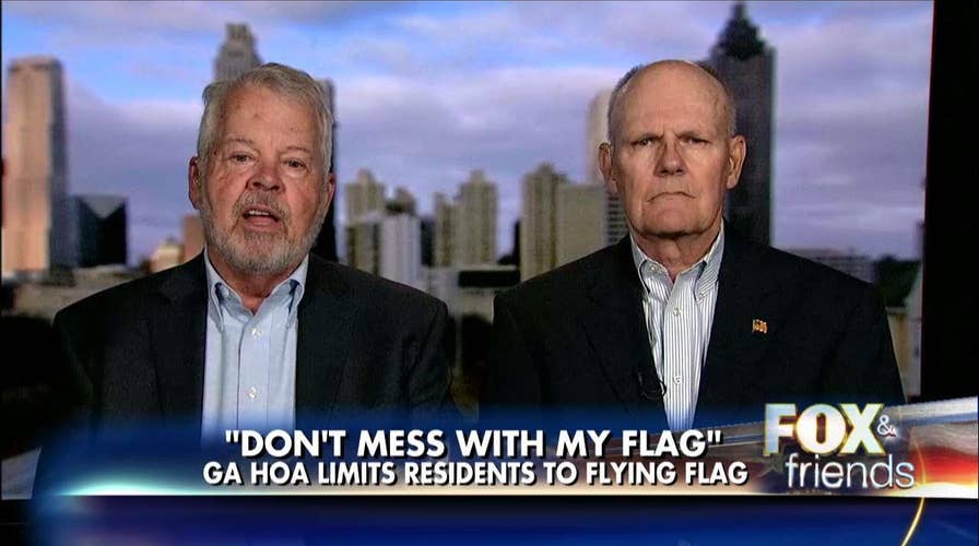 Vets refuse to take flags down