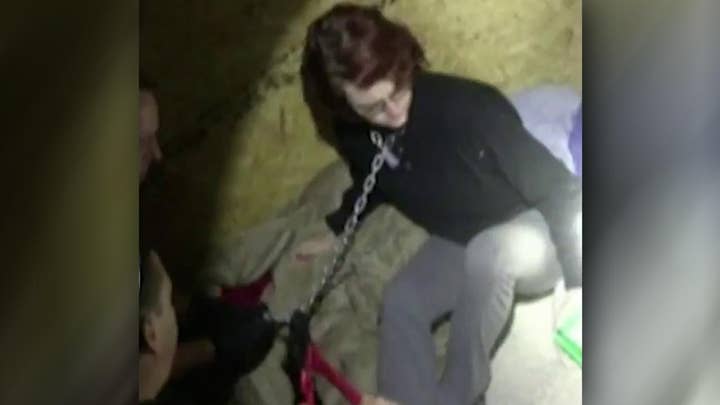 Cops save woman chained in metal container by serial killer 