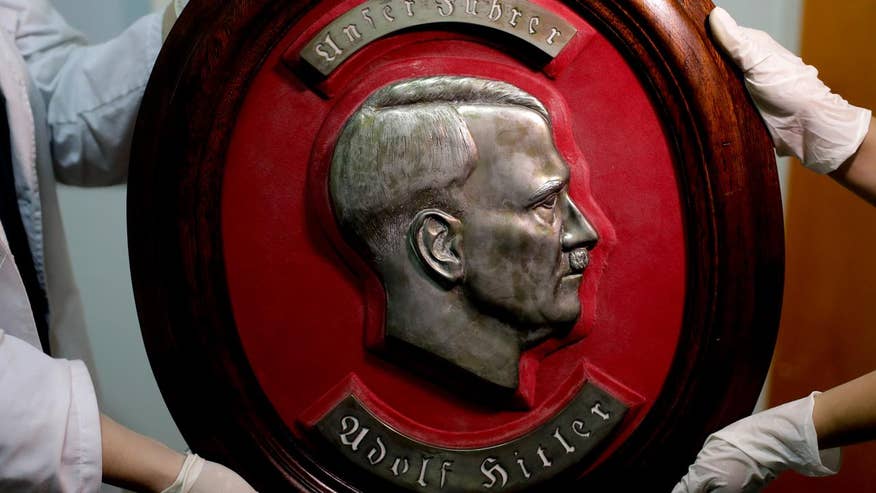 Interpol agents uncover a large trove of Nazi artifacts from musical instruments to images of Adolf Hitler hidden in a secret room in Argentina