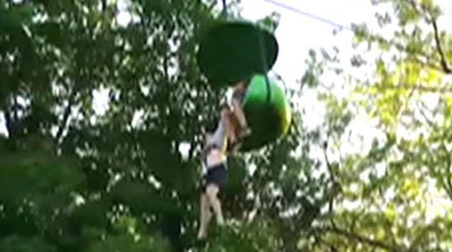 Crowd catches girl falling from amusement park ride