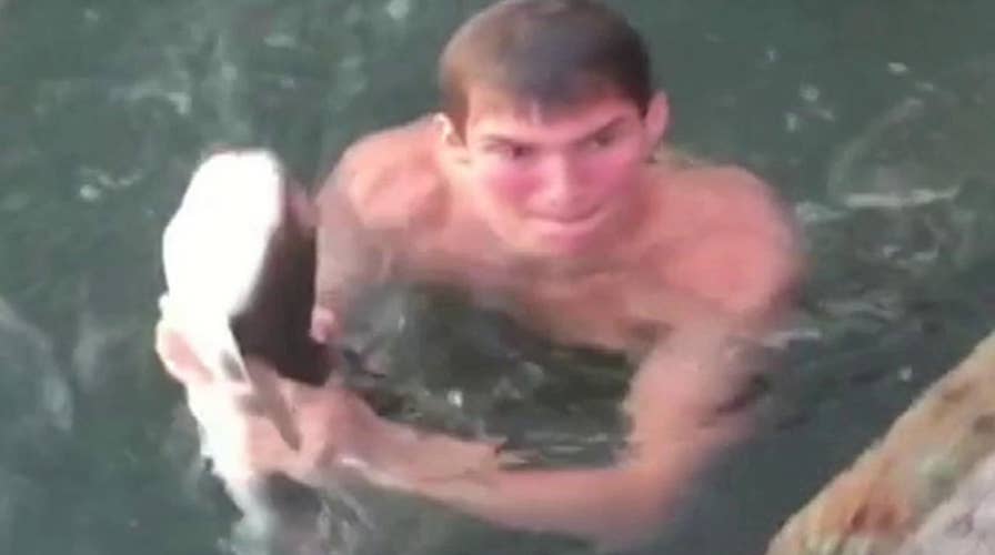 Man catching shark with bare hands caught on video