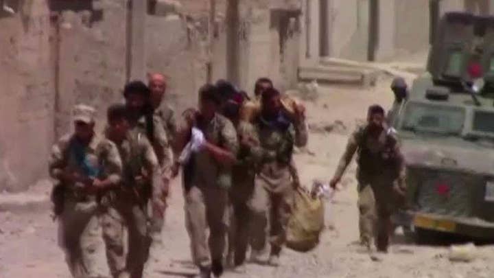 US-backed Syrian forces hit key milestone in Raqqa