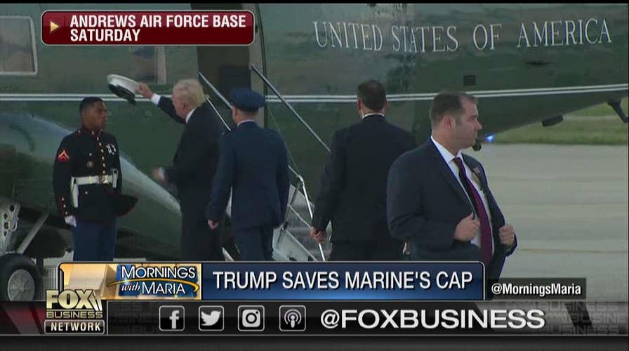 Trump retrieves Marine's hat.