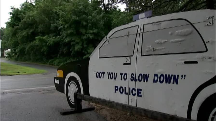 Homeowner uses cutout police cruiser to slow drivers down