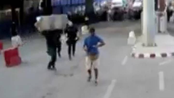 Cop hurls barrier at knife-wielding man who attacked police