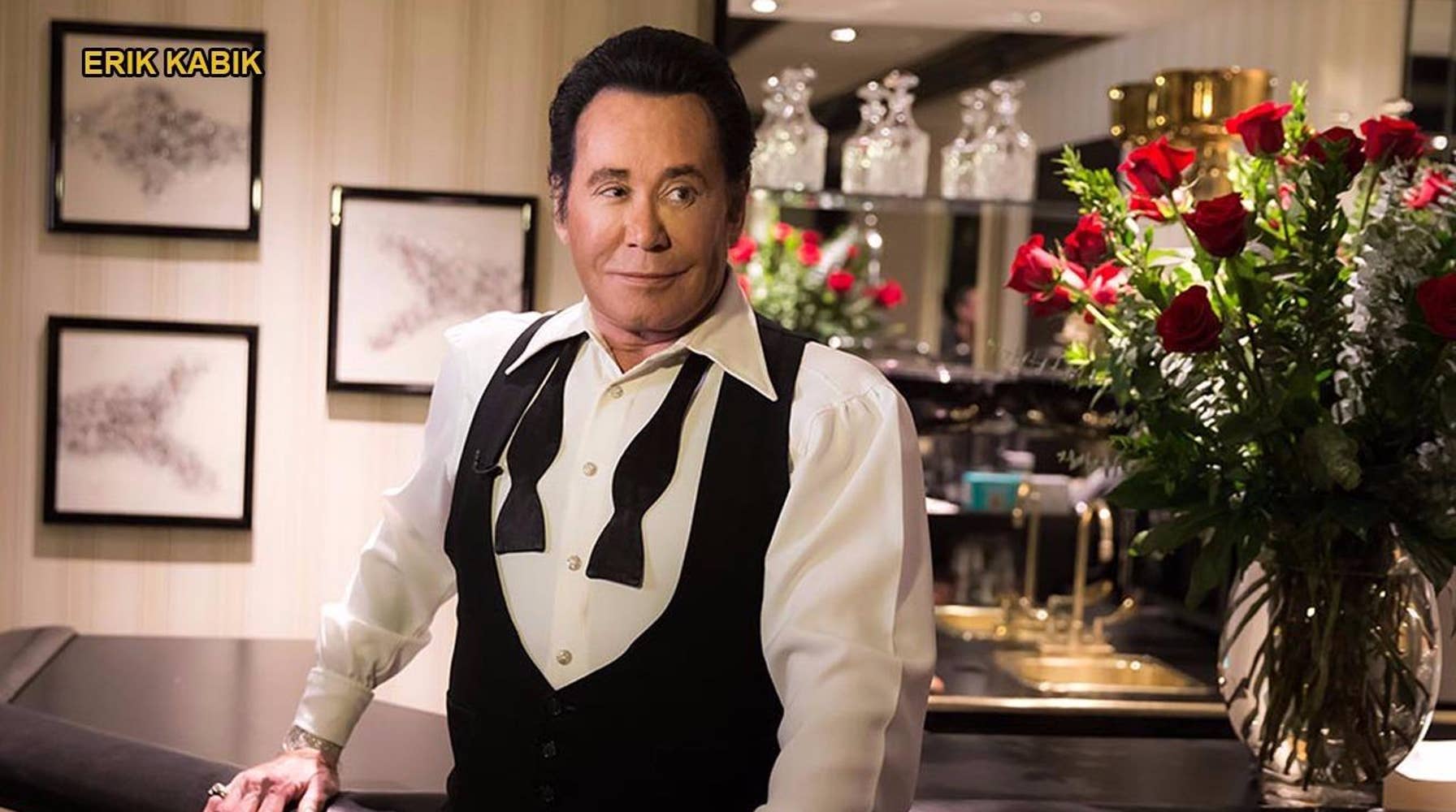 Wayne Newton performing on stage, embodying the golden era of Las Vegas entertainment