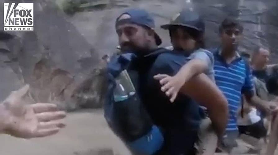 Hikers form human chain to cross flooded river in Utah