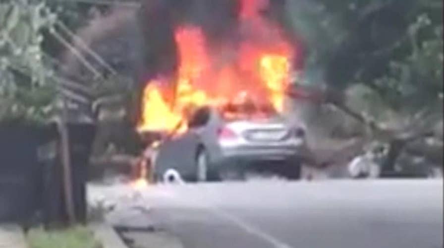 Man narrowly escapes burning car before it explodes