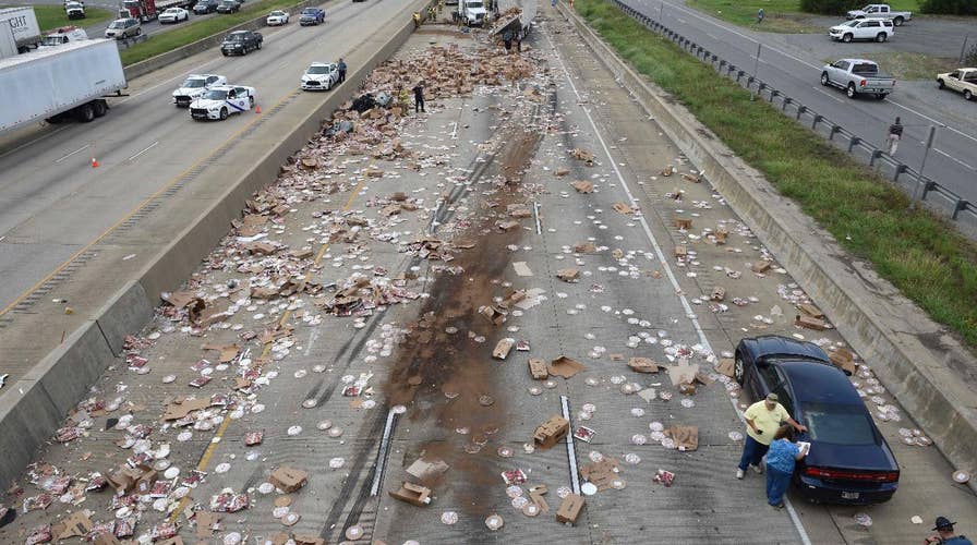 Pizza truck spills hundreds of frozen pizzas across highway