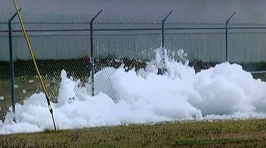 Foams fills airport hangar, briefly trapping people inside