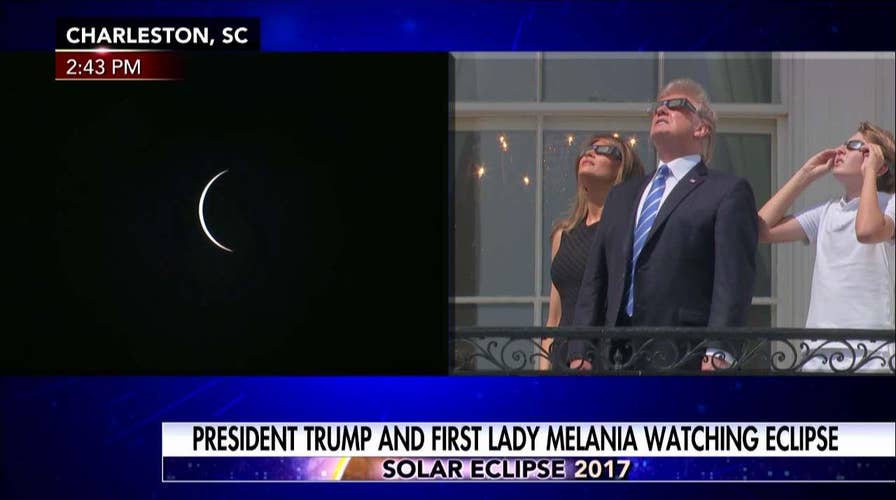 Trump watches eclipse at White House with Barron