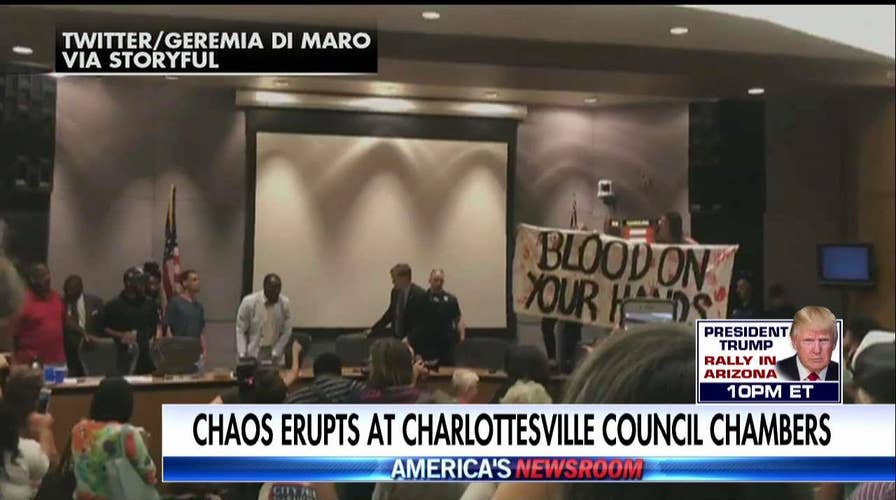 Chaotic protests at Charlottesville city council meeting.
