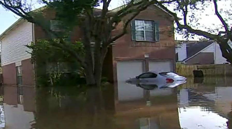 Houston tries to save some areas by flooding others