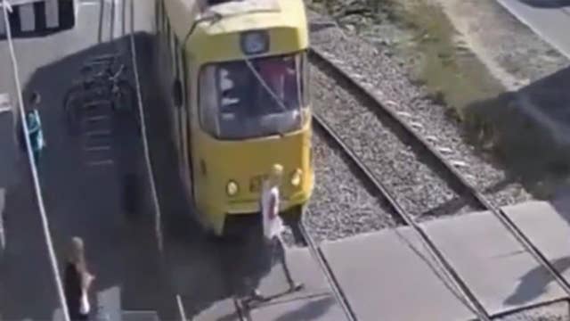 Warning, graphic video: Woman hit by train, loses leg