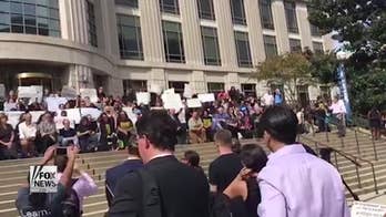 Protesters take a knee outside Sessions speech at Georgetown