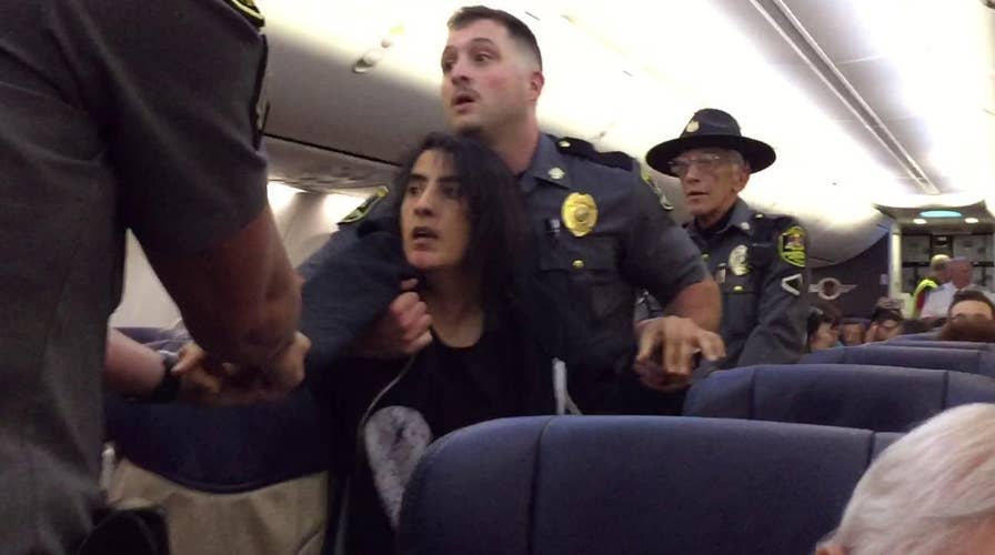 Southwest apologizes after cops remove woman from flight