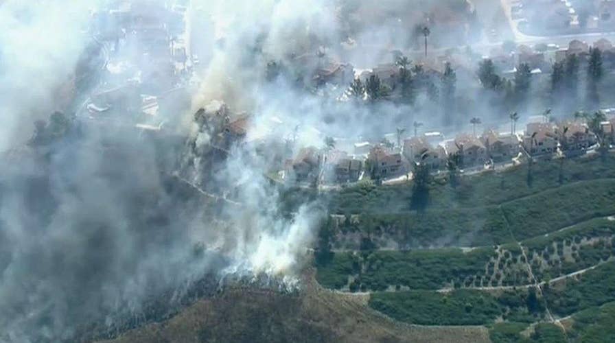 Wind-driven wildfire threatens homes in Anaheim, California