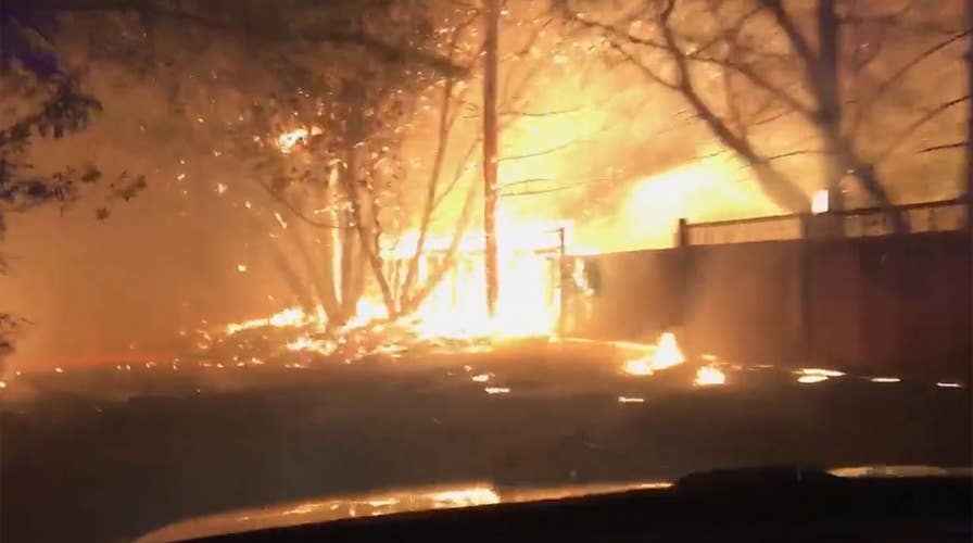 Police officer drives through raging wildfire in California