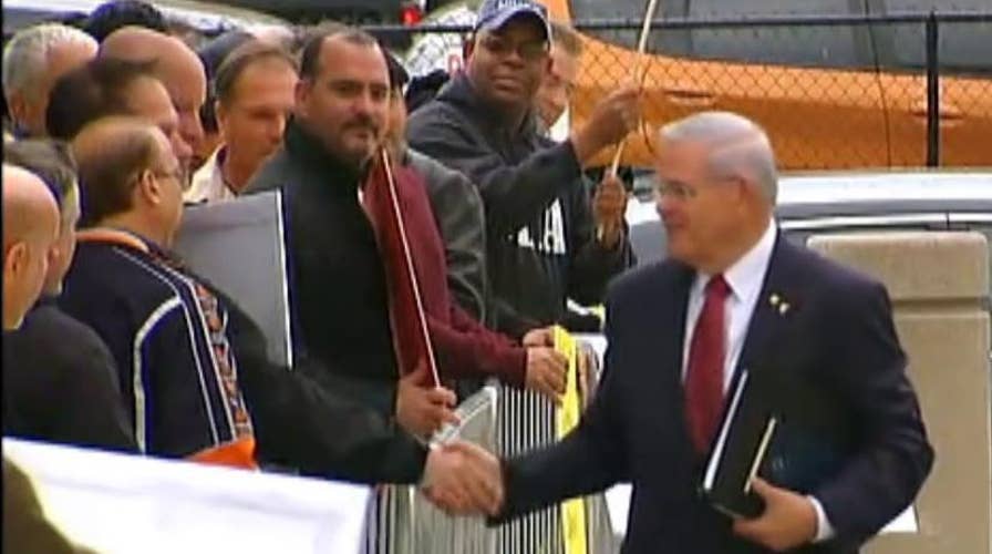 Sen. Bob Menendez greets supporters as he arrives for trial