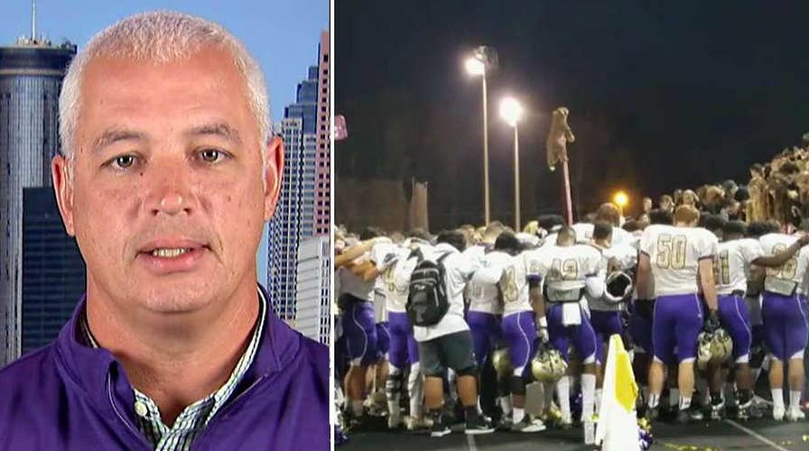 Students stand behind coach banned from prayer participation
