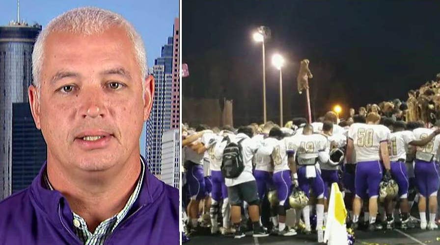 Students stand behind coach banned from prayer participation
