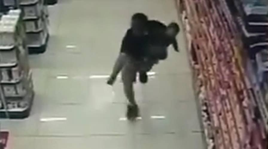 Off-duty cop, holding infant son, opens fire on suspects