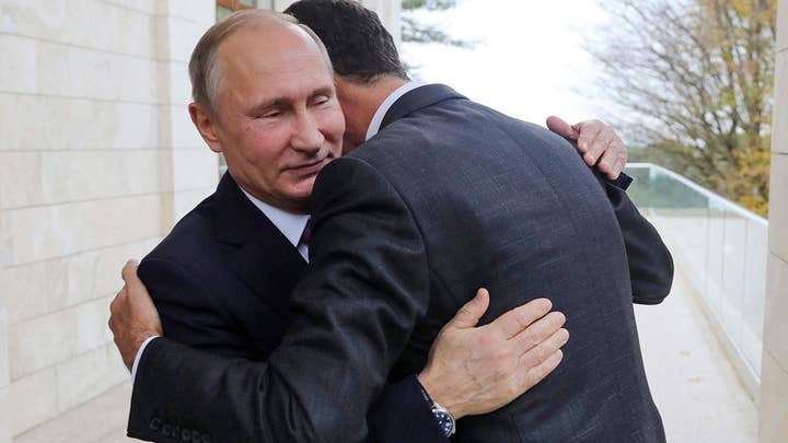 Syria's Assad embraces Putin in Russia