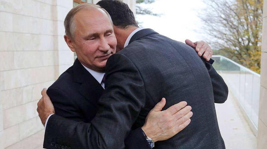 Syria's Assad embraces Putin in Russia