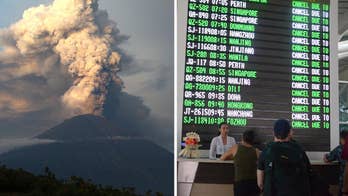 Tourists trapped in Bali for a second day as volcano threatens to 'spill over slopes'