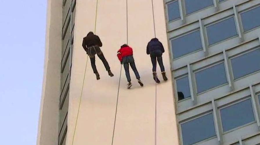 Todd Piro takes the plunge at Stamford's annual Santa Rappel