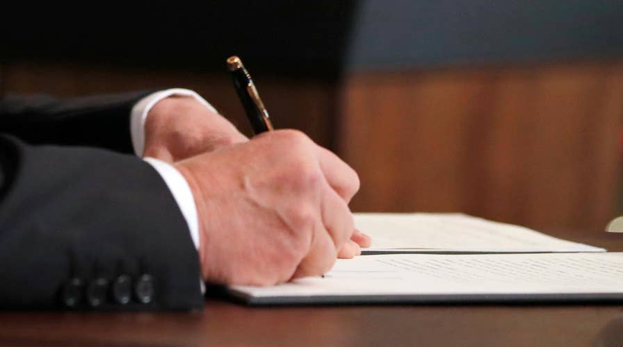 Trump signs two-week spending bill to avoid shutdown