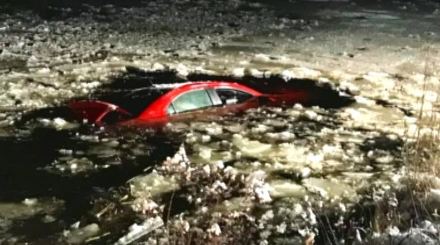 Man rescued after car plunges into frozen pond