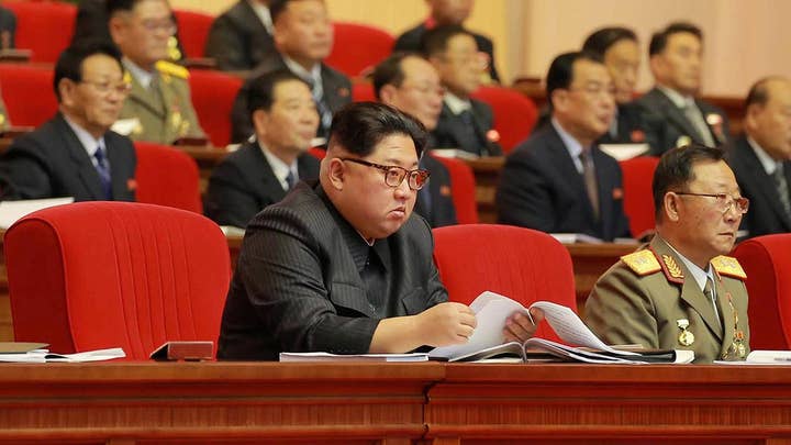 New images show Kim Jong Un with missile scientists