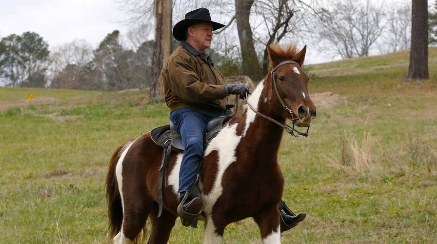 Roy Moore arrives on horseback to cast vote