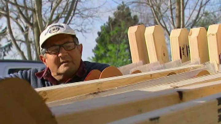 Man builds crosses to remember mass-shooting victims