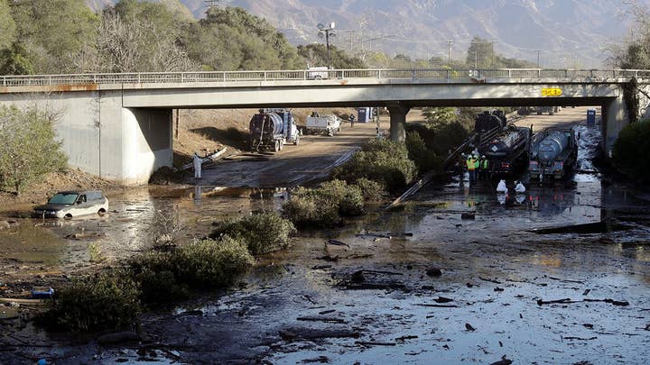 Crews working inch by inch to clear mud off 101 Freeway