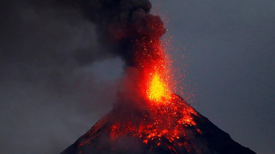 Erupting volcano lights up night sky in Philippines