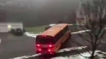 School bus full of children slides down icy road in Massachusetts, hits parked car