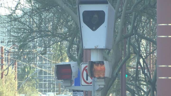 Photo red light, speed enforcement at intersection of debate