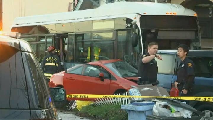 Emergency crews survey damage after bus crashes into homes